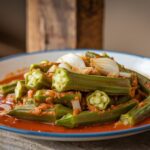 Okra stir-fry with onions and spices in a skillet